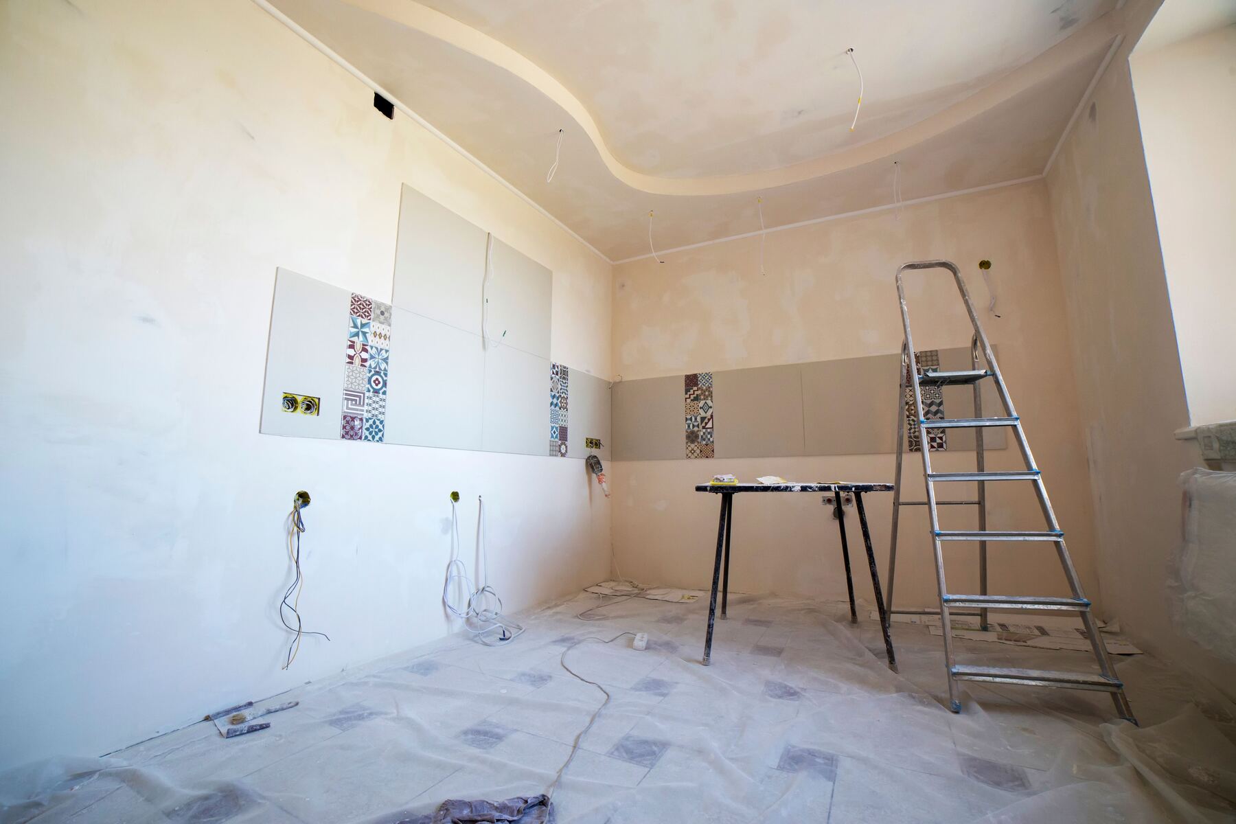 Bathroom mid-remodel with fresh plaster and tile