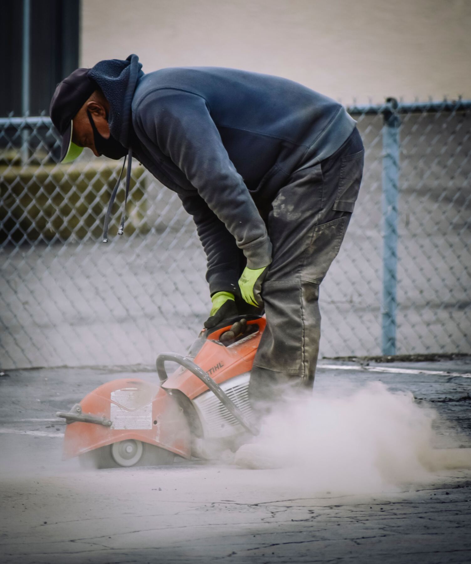 Worker cutting concrete for an outdoor hardscape